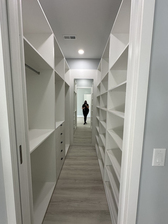 spacious closet featuring light hardwood / wood-style flooring