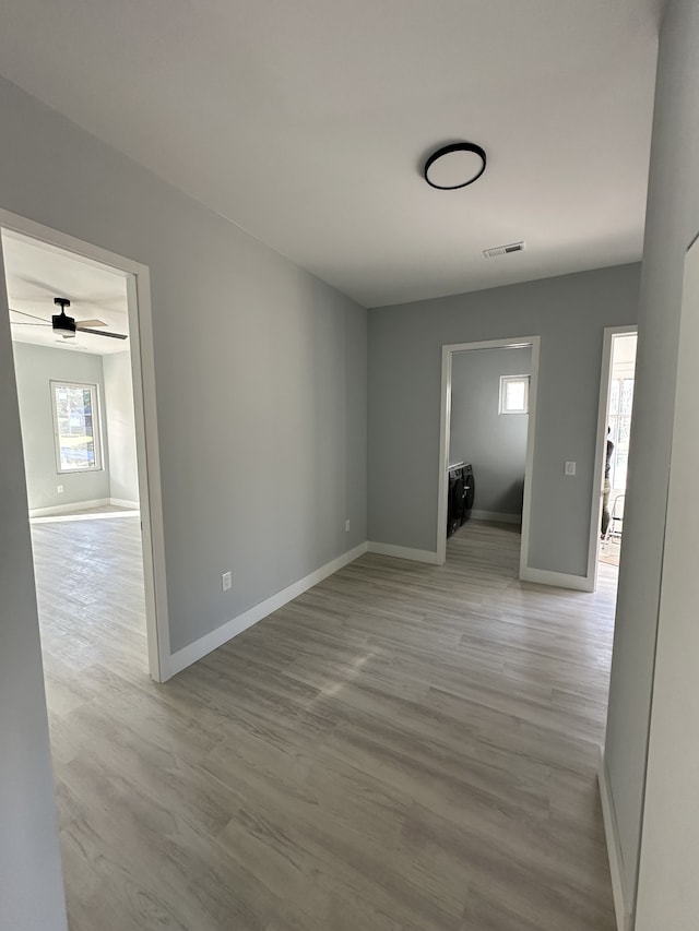 unfurnished room with ceiling fan and light wood-type flooring