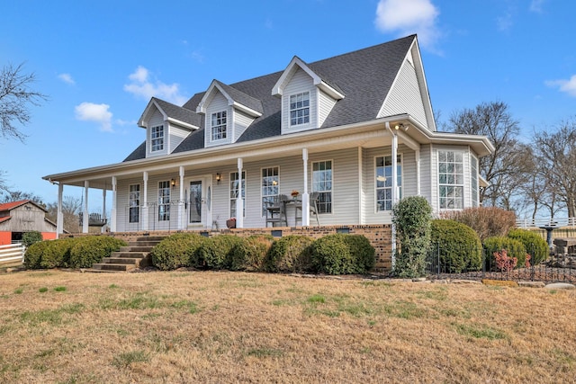 view of front of home featuring covered porch and a front lawn