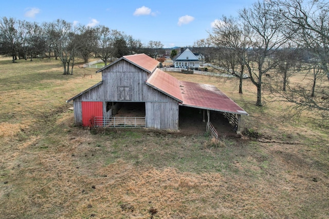 view of outdoor structure with a rural view and a lawn