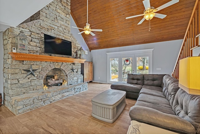 living room with a stone fireplace, high vaulted ceiling, wooden ceiling, ceiling fan, and light hardwood / wood-style floors