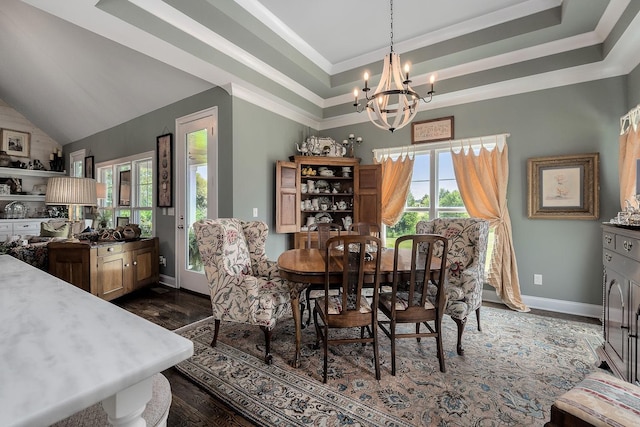 dining space featuring an inviting chandelier, lofted ceiling, and a raised ceiling