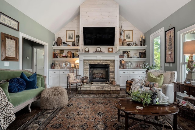 living room with lofted ceiling and a fireplace