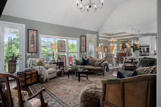 living room featuring an inviting chandelier, hardwood / wood-style floors, and high vaulted ceiling