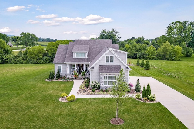 craftsman inspired home with a porch and a front lawn