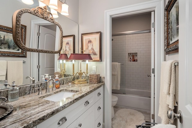 full bathroom featuring toilet, vanity, and shower / bath combination with glass door