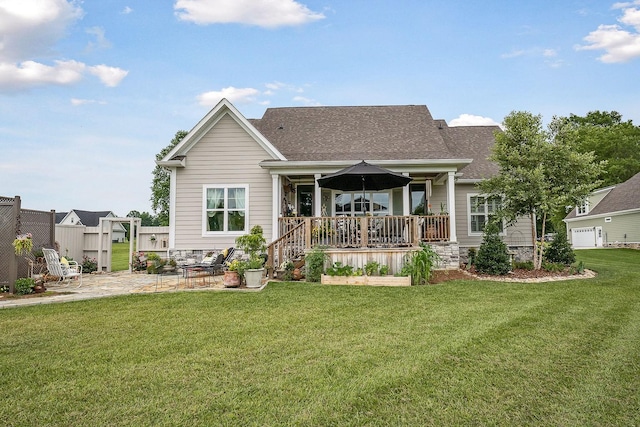 rear view of house featuring a yard and a patio