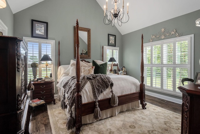 bedroom featuring vaulted ceiling, a chandelier, and light hardwood / wood-style floors