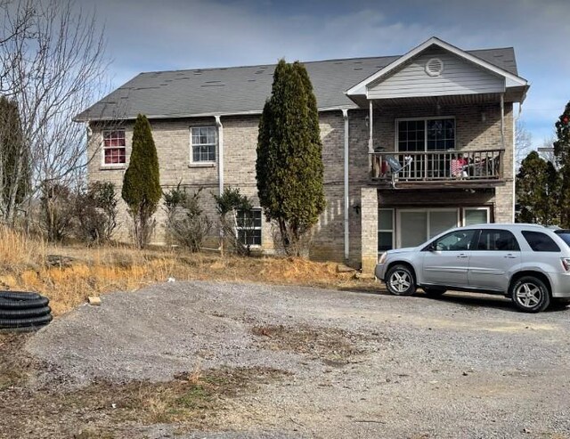 view of front of house featuring a balcony