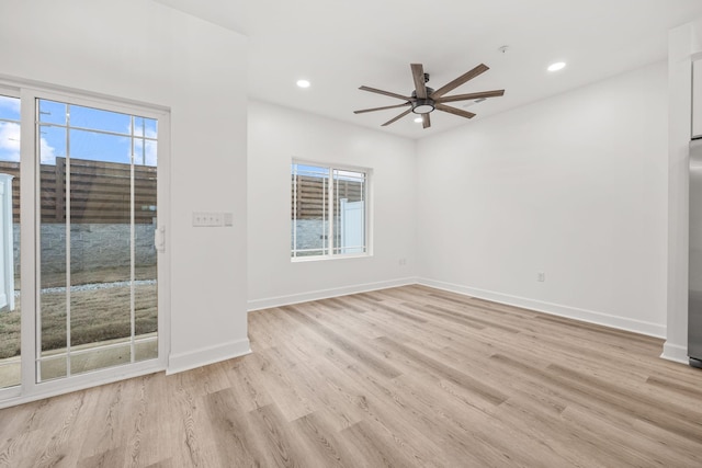 empty room with light wood-type flooring and ceiling fan