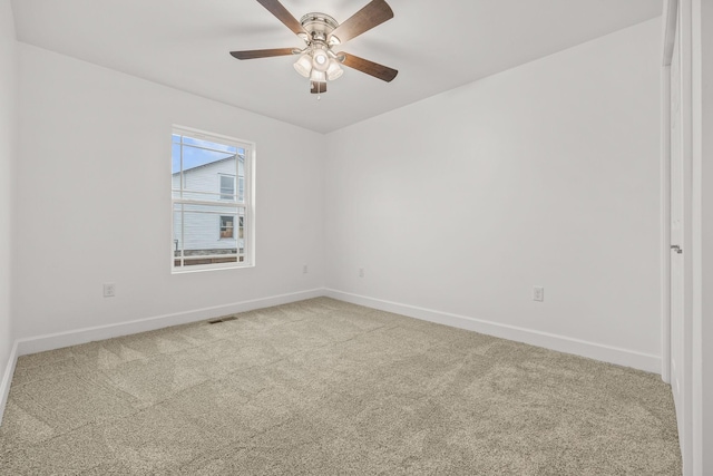 carpeted spare room featuring ceiling fan