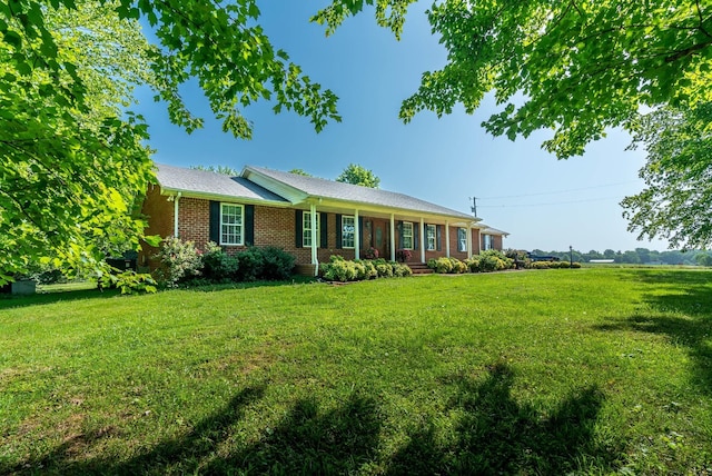 ranch-style house with covered porch and a front yard