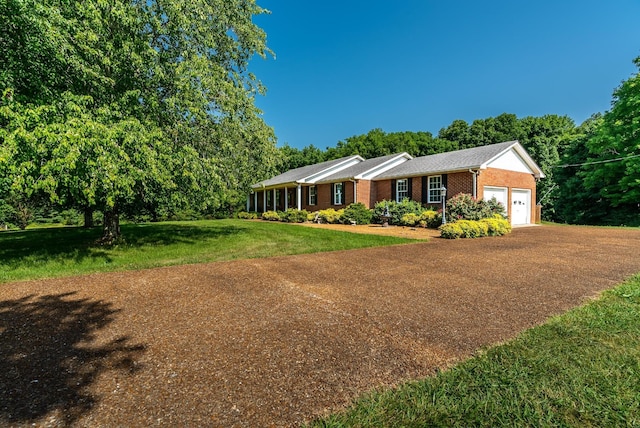 ranch-style home with a garage and a front yard