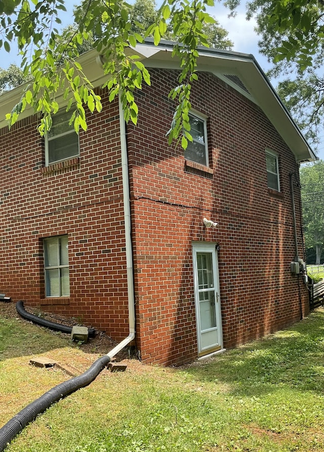 view of property exterior with a lawn