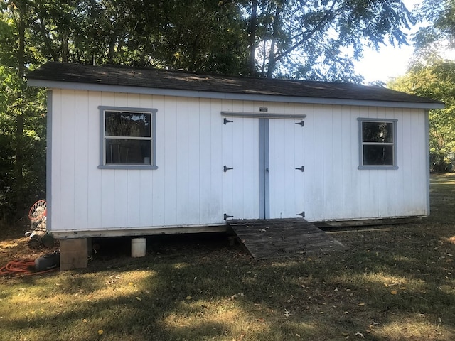 view of outbuilding with a lawn