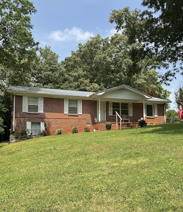 ranch-style home with a porch and a front lawn