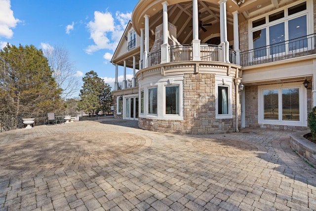 rear view of house with stone siding