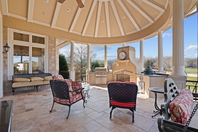 sunroom featuring vaulted ceiling with beams, wooden ceiling, plenty of natural light, and ornate columns