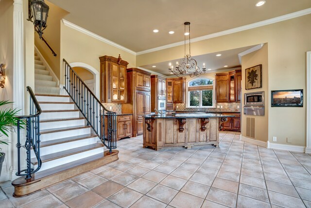 kitchen with a center island, brown cabinets, a breakfast bar area, stainless steel microwave, and glass insert cabinets