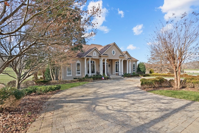 greek revival house featuring covered porch