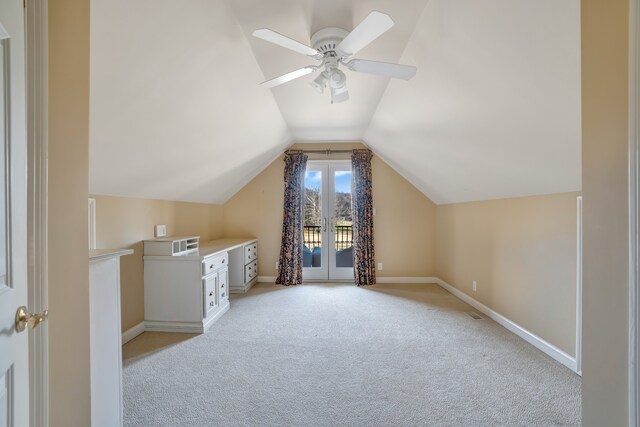 bonus room featuring baseboards, vaulted ceiling, a ceiling fan, and light colored carpet