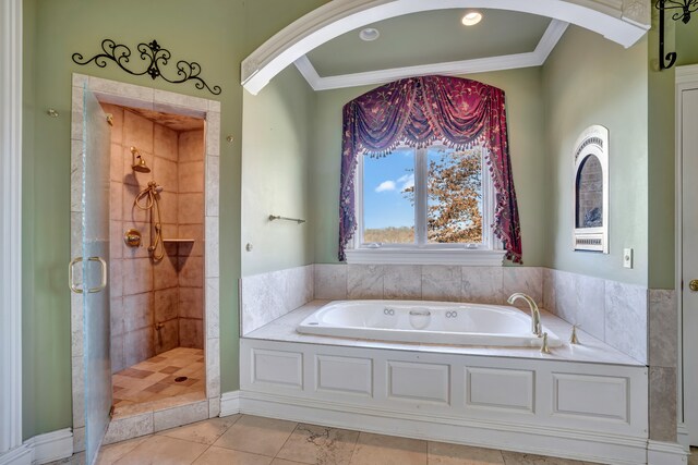 bathroom with ornamental molding, a stall shower, and a bath