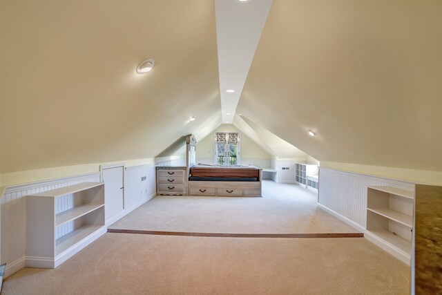 bonus room with vaulted ceiling, carpet floors, and built in features