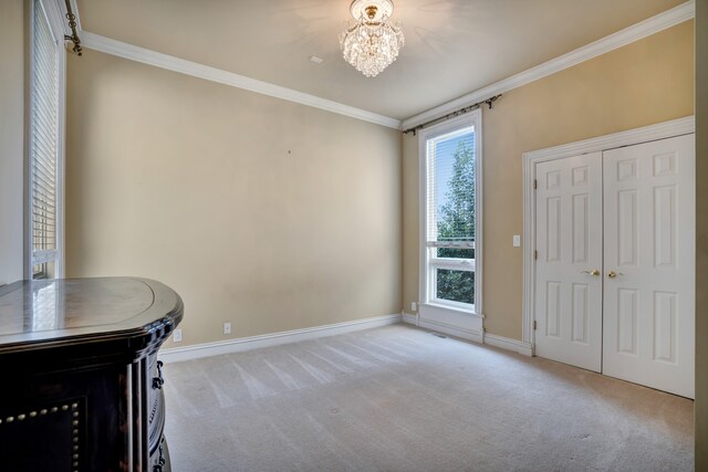 unfurnished office featuring ornamental molding, carpet flooring, and a notable chandelier