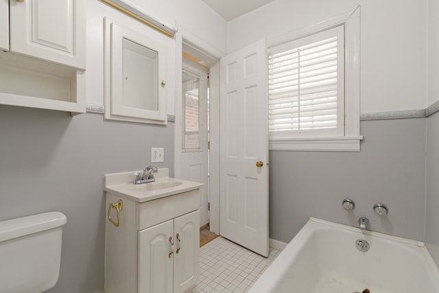 bathroom featuring vanity, toilet, tile patterned flooring, and a bathtub