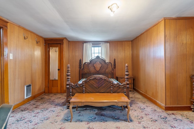 bedroom featuring wooden walls