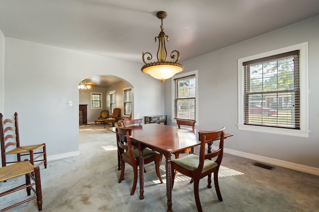 dining room with plenty of natural light and light colored carpet