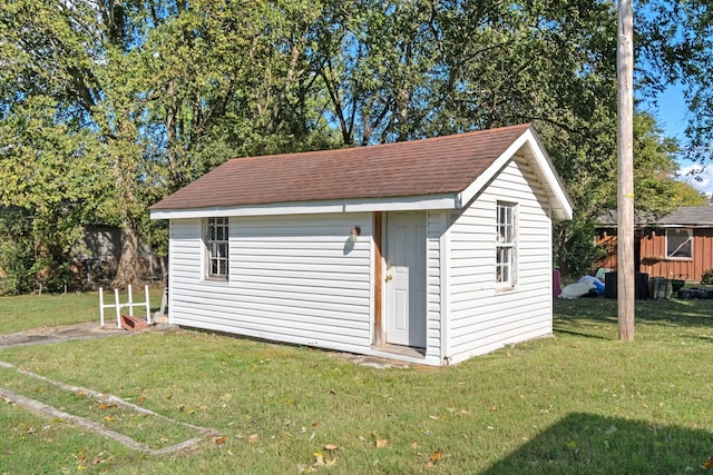 view of outbuilding with a yard