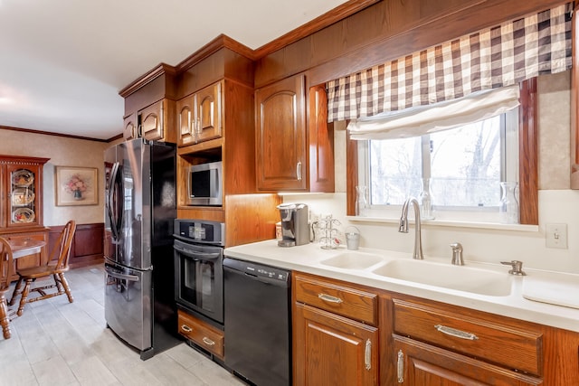 kitchen with sink, stainless steel appliances, and crown molding