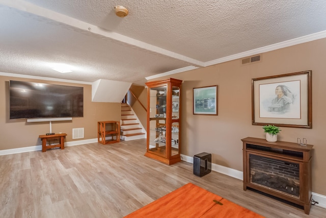 unfurnished living room featuring light hardwood / wood-style flooring and a textured ceiling