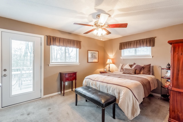 bedroom featuring ceiling fan, multiple windows, and carpet