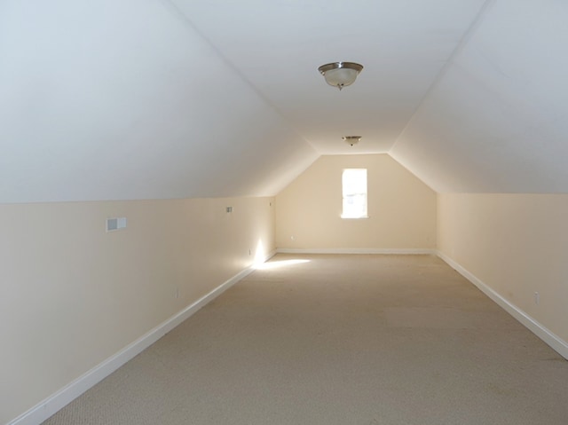 bonus room featuring light carpet and lofted ceiling