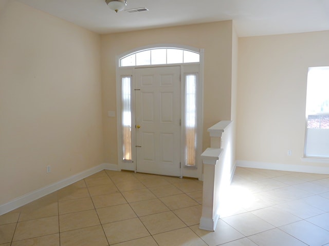 entrance foyer with plenty of natural light and light tile floors