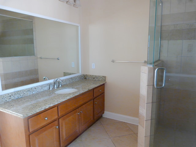 bathroom featuring tile flooring, vanity, and an enclosed shower