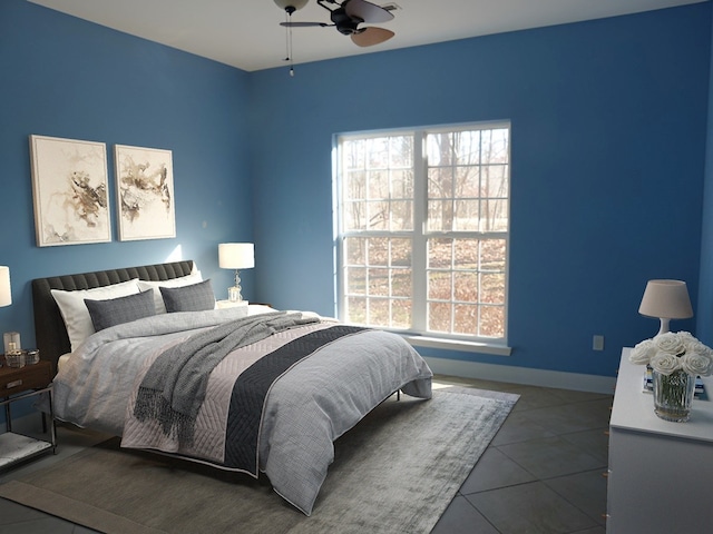 bedroom featuring multiple windows, dark tile flooring, and ceiling fan