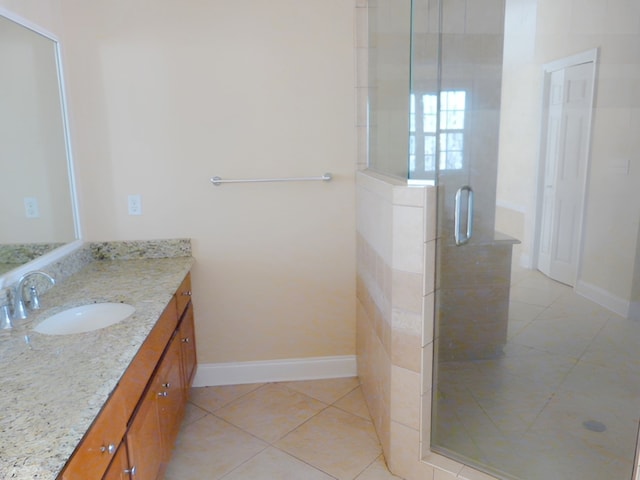 bathroom featuring an enclosed shower, tile flooring, and large vanity