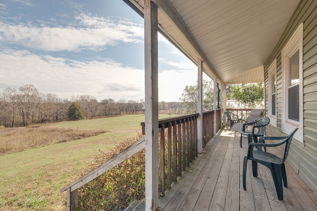 wooden deck featuring a lawn