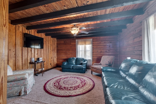 living room featuring wooden walls, ceiling fan, and carpet