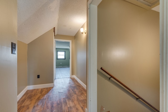 hallway with hardwood / wood-style flooring and a textured ceiling