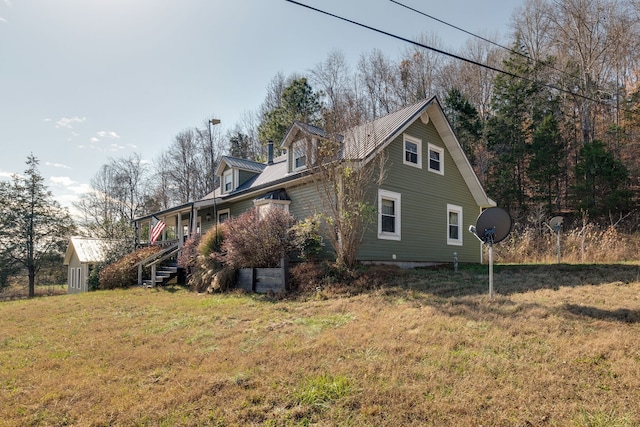 view of side of home with a yard