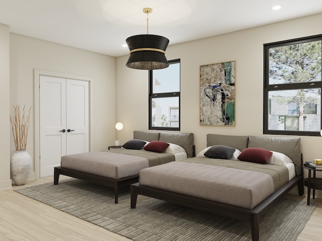 bedroom featuring a closet and light wood-type flooring