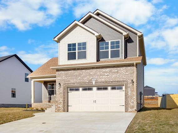 craftsman inspired home with a front yard and a garage