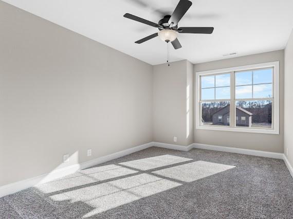 empty room with ceiling fan and carpet floors