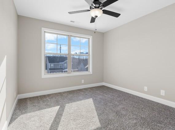 unfurnished room with ceiling fan and carpet floors