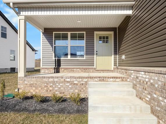 doorway to property featuring covered porch