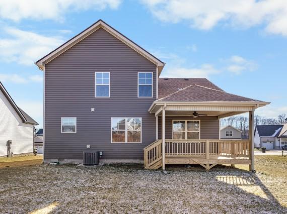 back of house featuring ceiling fan, cooling unit, and a wooden deck